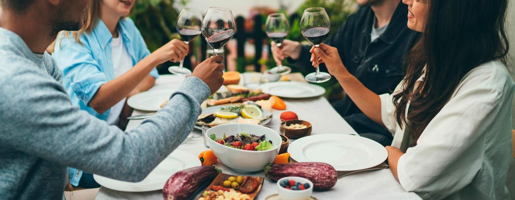 a group of people having a meal around an outdoor table