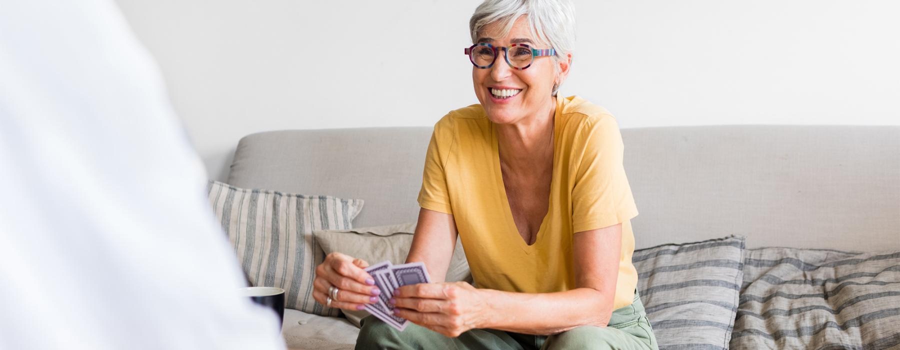 a person sitting on a couch playing cards