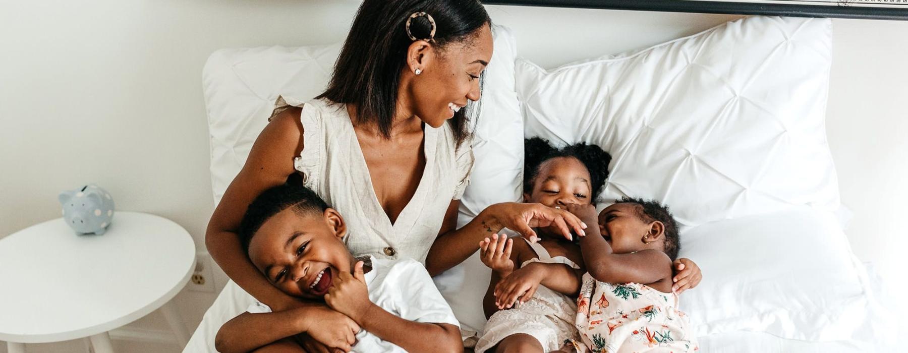 a woman on a bed with her children